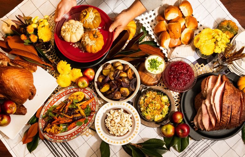 The chef Arnold Myint sets the table for a Friendsgiving dinner at his home in Nashville, Tenn., Nov. 15, 2021. For many LGBTQ Americans, especially those with immigrant roots, traditional notions of Thanksgiving and family may not apply. (Laura Partain/The New York Times)