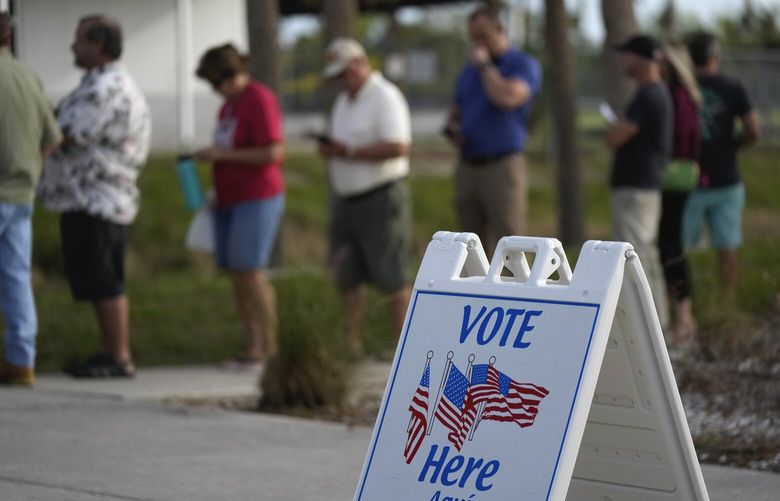 Lee County voters wait in line to cast their ballots at Wa-Ke Hatchee Recreation Center in Fort Myers, Fla, on Election Day, Tuesday, Nov. 8, 2022. After the area was devastated and thousands were left displaced by Hurricane Ian, Lee County extended their early voting period and permitted voters on Election Day to cast their ballot in any of the dozen open polling places. (AP Photo/Rebecca Blackwell) FLRB111 FLRB111