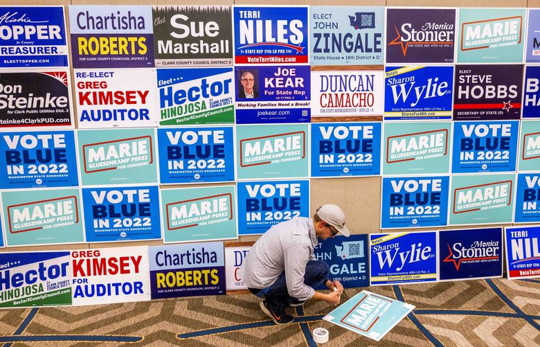 Tim Gowen, field director for the Marie Gluesenkamp Perez campaign, readies a wall political signage at a viewing party the Hilton Vancouver on Tuesday, Nov. 8, 2022.