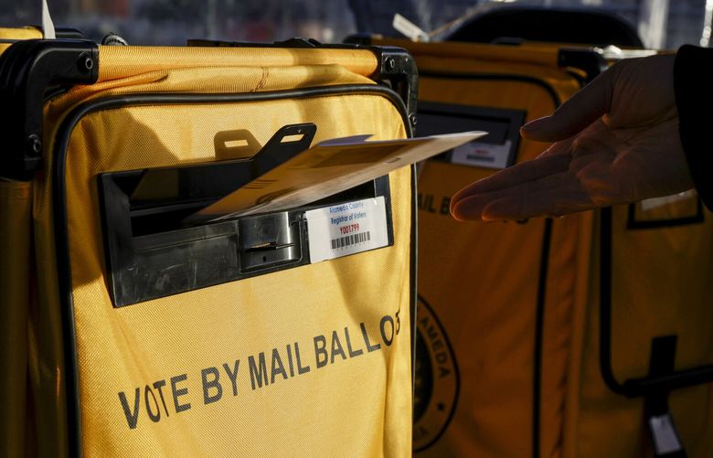 Nicole Hines drops her ballot in Alameda County’s mail-in ballot drive-thru on Election Day at the Alameda County Courthouse in Oakland, Calif., on Tuesday, Nov. 8, 2022. (BrontÃ« Wittpenn/San Francisco Chronicle via AP) CAFRA232 CAFRA232