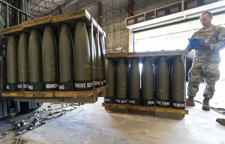 FILE – U.S. Air Force Staff Sgt. Cody Brown, right, with the 436th Aerial Port Squadron, checks pallets of 155 mm shells ultimately bound for Ukraine, April 29, 2022, at Dover Air Force Base, Del. Officials say the U.S. will send $400 million more in military aid to Ukraine amid concerns financial assistance for the war against Russia could decline if Republicans take control of Congress. (AP Photo/Alex Brandon, File) WX101 WX101