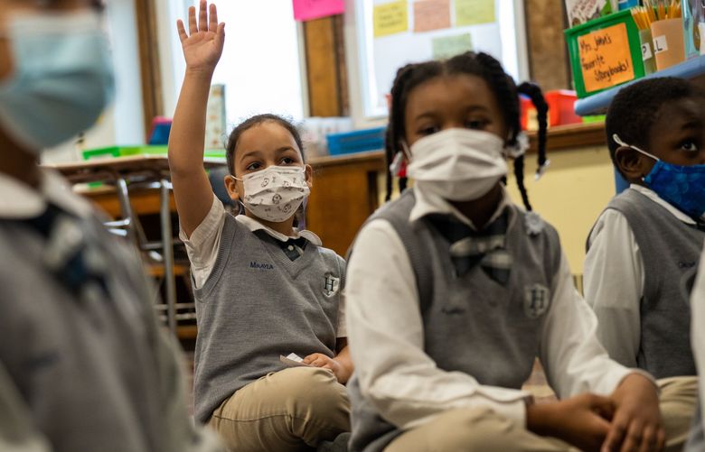 FILE – A first-grade class at in Bridgeport, Conn., on Feb. 23, 2022. In a so-called natural experiment, two school districts in Boston maintained masking after mandates had been lifted in others, enabling a unique comparison. The bottom line: Masking mandates were linked with significantly reduced numbers of COVID cases. (Christopher Capozziello/The New York Times) XNYT12 XNYT12 (CHRISTOPHER CAPOZZIELLO / NYT)