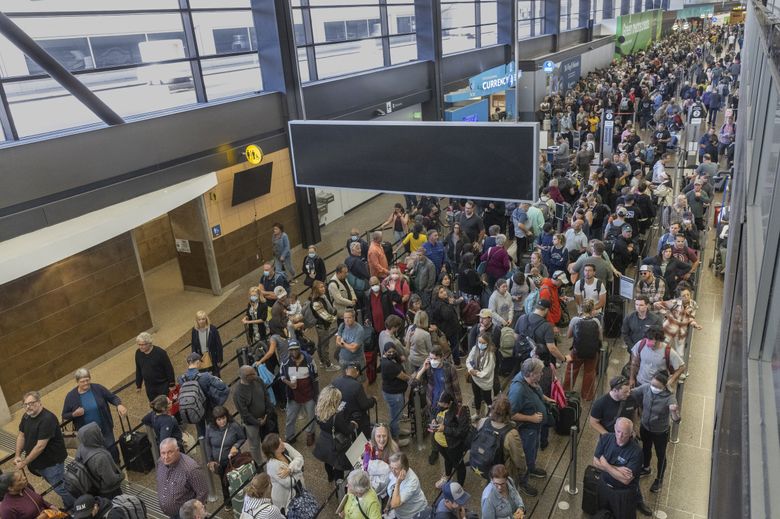 Passengers endured long delays in general security lines at Sea-Tac Airport in September. For a time, lines led out to the parking garage and wait times were up to 90 minutes. (Ellen M. Banner / The Seattle Times)