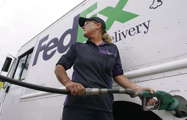 Federal Express truck driver Paula Crayne gases up her delivery truck with diesel fuel in Springfield, Ill.