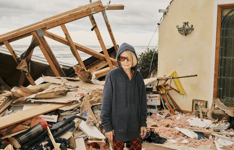 Nina Lavigna stands near the entrance of her home, which was split in half by storm surge from Hurricane Nicole, on Wilbur Beach in Wilbur-By-The-Sea, Fla. on Thursday, Nov. 10, 2022. Hurricane Nicole made landfall in Florida overnight before quickly being downgraded to a tropical storm, but the sprawling weather system was battering the state with high winds, heavy rain and life-threatening coastal flooding as it moved west. (Zack Wittman/The New York Times) XNYT184 XNYT184