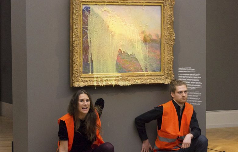 Climate protesters of Last Generation after throwing mashed potatoes at the Claude Monet painting “Les Meulesâ€ at Potsdamâ€™s Barberini Museum on Sunday Oct. 24, 2022, to protest fossil fuel extraction. (Last Generation via AP) LON802 LON802