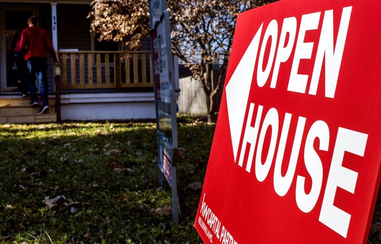 An “Open House” sign is displayed as potential home buyers arrive at a property for sale in Columbus, Ohio, in 2017. (Ty Wright/Bloomberg)