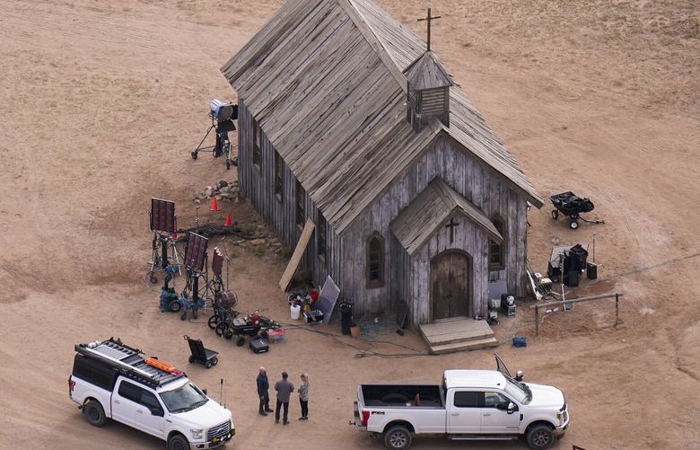 FILE – This aerial photo shows part of the Bonanza Creek Ranch film set in Santa Fe, N.M., on Saturday, Oct. 23, 2021, where cinematographer Halyna Hutchins died from a gun fired by actor Alec Baldwin. The family of a cinematographer shot and killed by Alec Baldwin on the set of the film â€œRustâ€ has agreed to settle a lawsuit against Baldwin and the movie’s producers, and production will resume on the project. (AP Photo/Jae C. Hong, File)