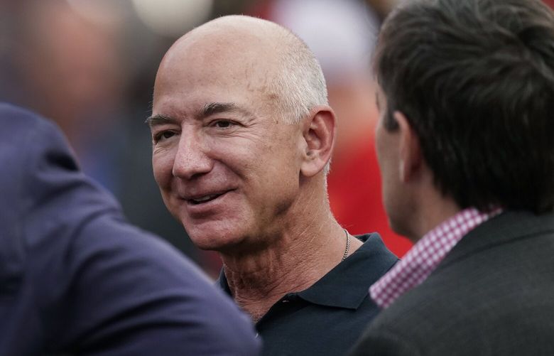 Amazon founder Jeff Bezos is seen on the sidelines before the start of an NFL football game, Sept. 15, 2022, in Kansas City, Mo. Bezos said in an interview with CNN that he will give away the majority of his wealth during his lifetime. The billionaire didn’t specify how – or to whom – he will give away the money. (AP Photo/Charlie Riedel) 