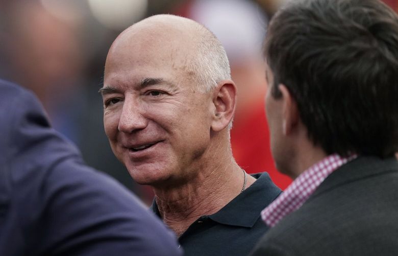 FILE – Amazon founder Jeff Bezos is seen on the sidelines before the start of an NFL football game on Sept. 15, 2022, in Kansas City, Mo. A former housekeeper for Bezos says she and other employees suffered unsafe working conditions that included being forced to climb out a laundry room window to get to a bathroom. In a lawsuit filed in Seattle this week, a longtime housekeeper claims she was discriminated and retaliated against when she complained about a lack of rest breaks or an area where staff could eat. (AP Photo/Charlie Riedel, File) FX414 FX414