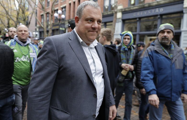 Seattle Sounders general manager Garth Lagerwey walks with fans Sunday, Nov. 10, 2019, before the MLS Cup championship soccer match against Toronto FC in Seattle. (AP Photo/Ted S. Warren)