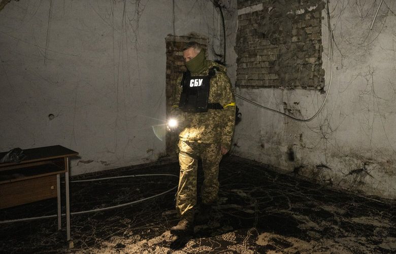 A member of the Ukrainian security forces in a basement used as a prison by occupying Russian forces in Kherson, Ukraine, on Nov. 16, 2022. The liberation of Kherson was joyous, but the revelations about what happened during occupation are anything but; Ukrainian authorities found 11 detention centers, including four sites they believed the Russians used to hold and torture civilians. (Lynsey Addario/The New York Times) — NO SALES — XNYT254 XNYT254