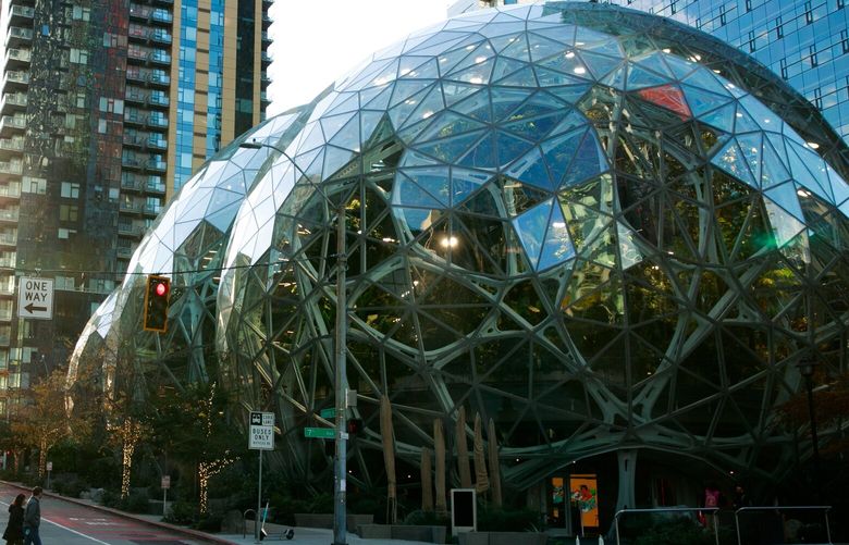Pedestrians walk by Amazon’s Spheres at the corner of Seventh Avenue and Lenora Street in Seattle on Tuesday, Nov. 15, 2022. 222198