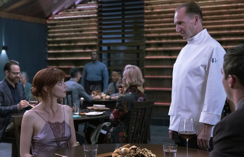 This image released by Searchlight Pictures shows Ralph Fiennes, right, and Anya Taylor-Joy in a scene from the film “The Menu.” (Eric Zachanowich/Searchlight Pictures via AP) NYET127 NYET127