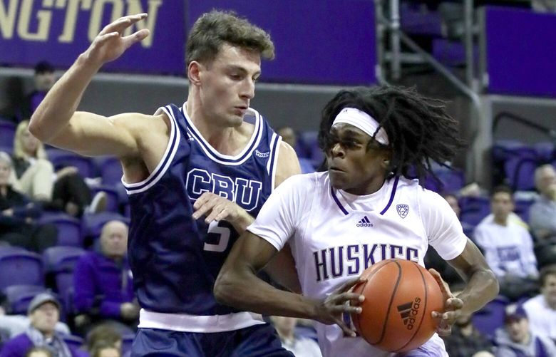 Washington Huskies guard Keyon Menifield drives the lane with Cal Baptist’s Reed Nottage defending in the first half Thursday night at Alaska Airlines Arena in Seattle, Washington on November 17, 2022.