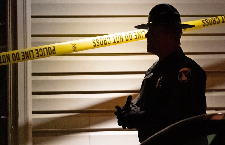 An Idaho State Police trooper walks near police tape on Thursday, Nov. 17, 2022, in Moscow, Idaho, at the residence where four University of Idaho students were found dead on Sunday, Nov. 13, 2022 near campus. IDTW201