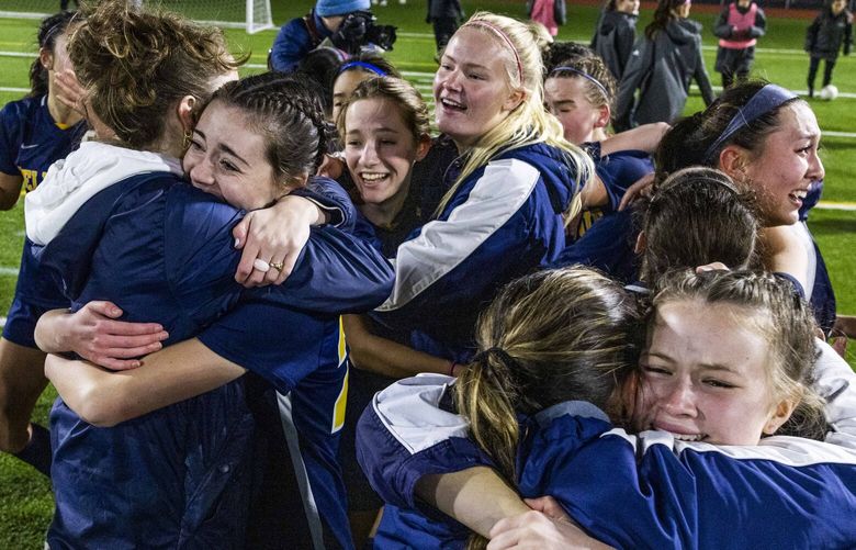 Bellevue High School celebrates their WIAA 3A girls soccer championship win at Sparks Stadium in Puyallup on Nov. 19, 2022.
