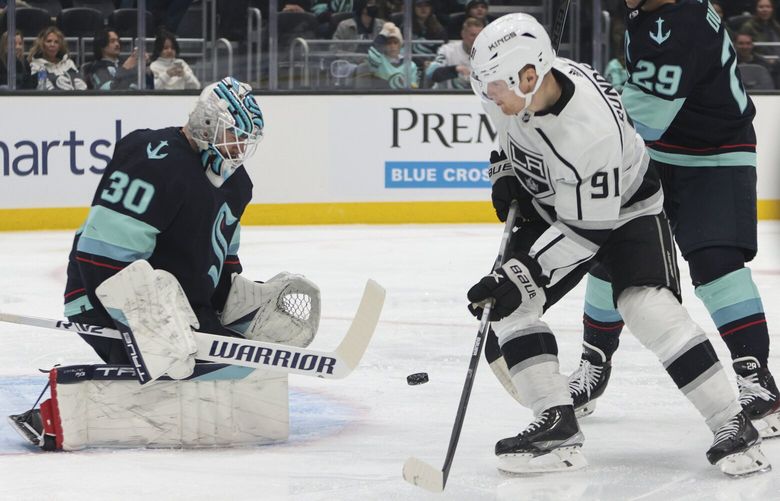 Seattle Kraken goaltender Martin Jones makes a save on a shot by Los Angeles Kings right wing Carl Grundstrom (91) as Kraken’s Vince Dunn defends during the first period of an NHL hockey game Saturday, Nov. 19, 2022, in Seattle. (AP Photo/Jason Redmond) WAJR101 WAJR101