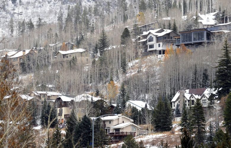 Houses dot a hillside in the ski resort town of Vail, Colo., on Oct. 25, 2022. A dearth of affordable housing threatens dozens of businesses that serve up food, fun and fashion for the thousands of visitors who converge on the area during ski season. (AP Photo/Thomas Peipert) FX403 FX403