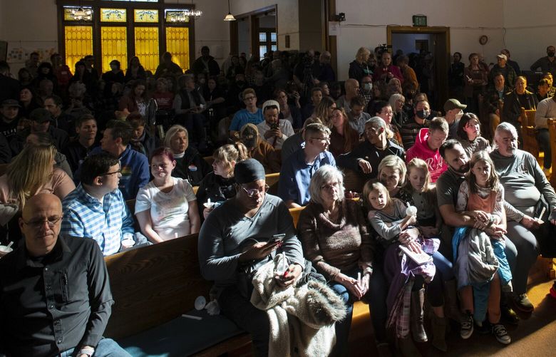 Light shines through the window of All Souls Unitarian Church illuminating community members that gathered for a service following Saturday’s fatal shooting at Club Q in Colorado Springs, Colo., on Sunday, Nov. 20, 2022. (Parker Seibold/The Gazette via AP) COCOL604 COCOL604