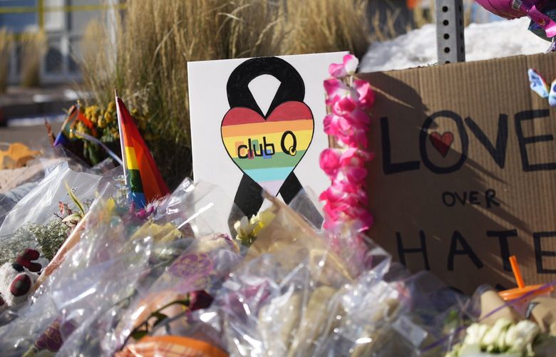 Bouquets of flowers sit on a corner near the site of a mass shooting at a gay bar Monday, Nov. 21, 2022, in Colorado Springs, Colo. (AP Photo/David Zalubowski) CODZ105 CODZ105