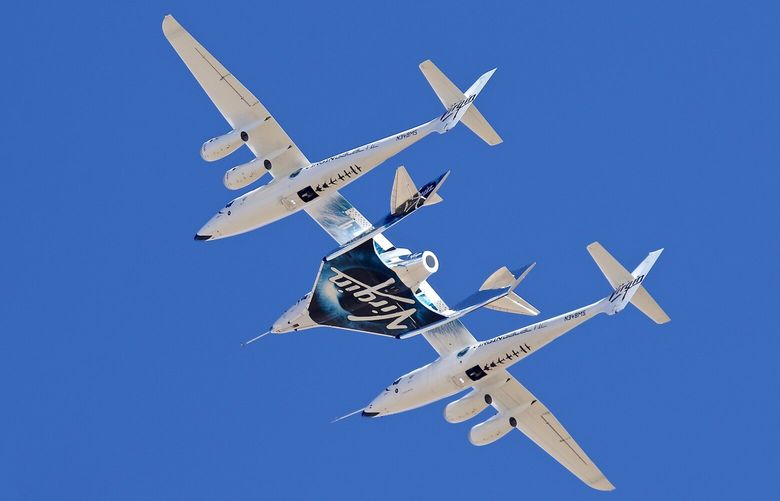 Virgin Galactic’s VSS Unity departs Mojave Air & Space Port in Mojave, Calif. for the final time as Virgin Galactic shifts its SpaceFlight operations to New Mexico on Thursday, Feb. 13, 2020. Virgin Galactic’s spaceship VSS Unity, tucked under the wing of its special carrier aircraft, headed east from Southern California on a long-awaited ferry flight to its new home in New Mexico where it will be prepared for commercial operations carrying tourists on hops into space, the company said. (Matt Hartman via AP)