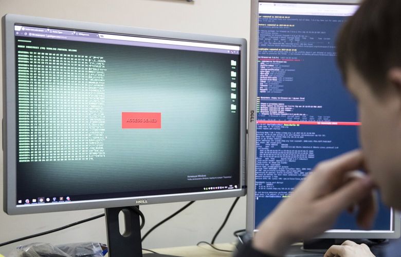 An employee of Global Cyber Security Company Group-IB develops a computer code in an office in Moscow, Russia, Wednesday, Oct. 25, 2017. A new strain of malicious software has paralyzed computers at a Ukrainian airport, the Ukrainian capital’s subway and at some independent Russian media. Moscow-based Global Cyber Security Company Group-IB said in a statement Wednesday the ransomware called BadRabbit also tried to penetrate the computers of major Russian banks but failed. None of the banks has reported any attacks. (AP Photo/Pavel Golovkin)