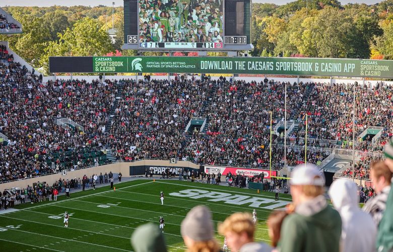 An advertisement promoted a betting app at Michigan State’s football game against Ohio State on Oct. 8, 2022, in East Lansing, Mich. In order to reap millions of dollars in fees, universities are partnering with betting companies to introduce their students and sports fans to online gambling. (Stephen Speranza/The New York Times) 