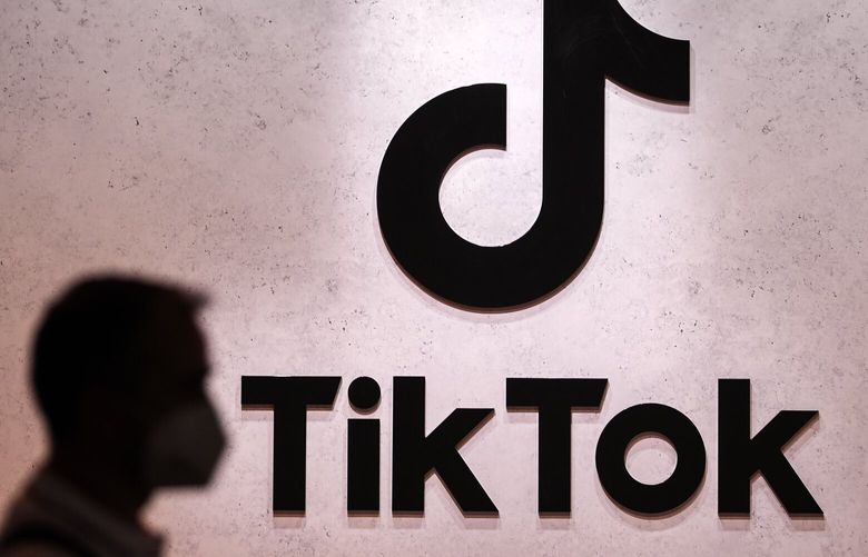 FILE – A visitor passes the TikTok exhibition stands at the Gamescom computer gaming fair in Cologne, Germany, Thursday, Aug. 25, 2022. A Russian court has fined TikTok for failing to delete LGBT material in what is the country’s latest crackdown on Big Tech companies. The court in Moscow on Tuesday, Oct. 4, 2022 issued the $50,000 penalty to the short-video sharing platform, following a complaint by Russian regulators. TikTok, which is owned by China’s ByteDance Ltd., didn’t immediately respond to a request for comment. (AP Photo/Martin Meissner, File)