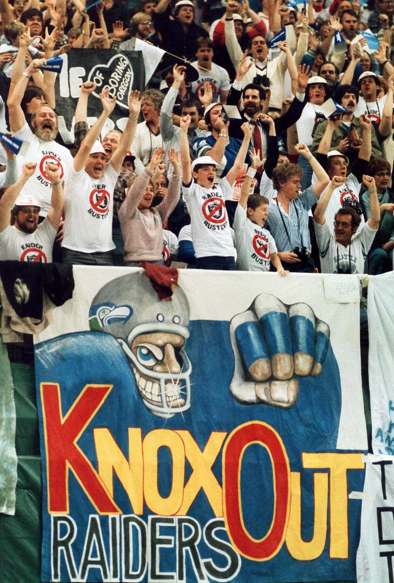 Oakland Raiders fans cheer during an NFL game against the Los