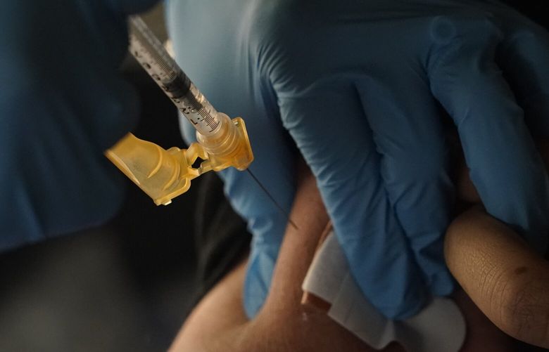 A Jackson-Hinds Comprehensive Health Center nurse administers a Moderna COVID-19 booster vaccine at an inoculation station next to Jackson State University in Jackson, Miss., Friday, Nov. 18, 2022. (AP Photo/Rogelio V. Solis) MSRS116 MSRS116