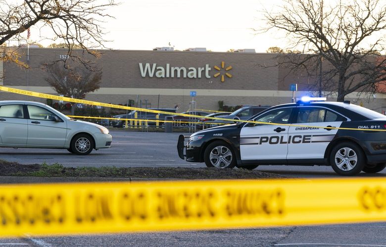 Law enforcement work the scene of a mass shooting at a Walmart, Wednesday, Nov. 23, 2022, in Chesapeake, Va.  The store was busy just before the shooting Tuesday night with people stocking up ahead of the Thanksgiving holiday.    (AP Photo/Alex Brandon) VAAB112 VAAB112