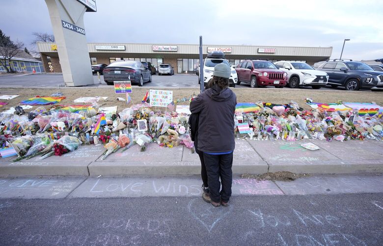 A couple hug at a makeshift memorial Wednesday, Nov. 23, 2022, in Colorado Springs, Colo., for the victims of a mass shooting last weekend at Club Q, a gay nightclub. (AP Photo/David Zalubowski)