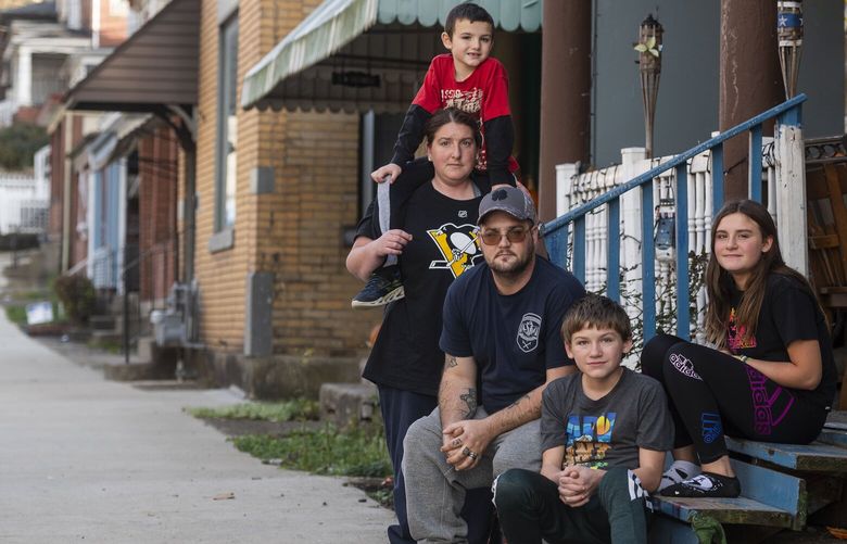 Thomas Horton and his wife, Pamela Mudge, with their children, Zander, 7; Ayden, 14; and Zoey, 13, outside their home in Pitcairn, Pa., on Nov. 4, 2022. Tax credit payments of $750 a month raised cash income by nearly 50 percent for Horton and Mudge, lifting them above the poverty line and providing them breaks from the family’s frugal norms. (Nate Smallwood/The New York Times) XNYT1