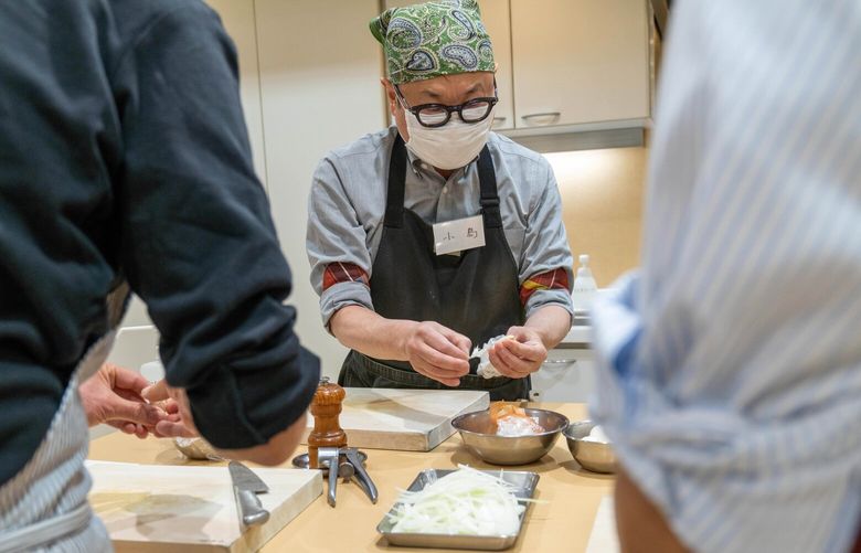 Students in Better Home’s cooking class for men in Tokyo work as a team.