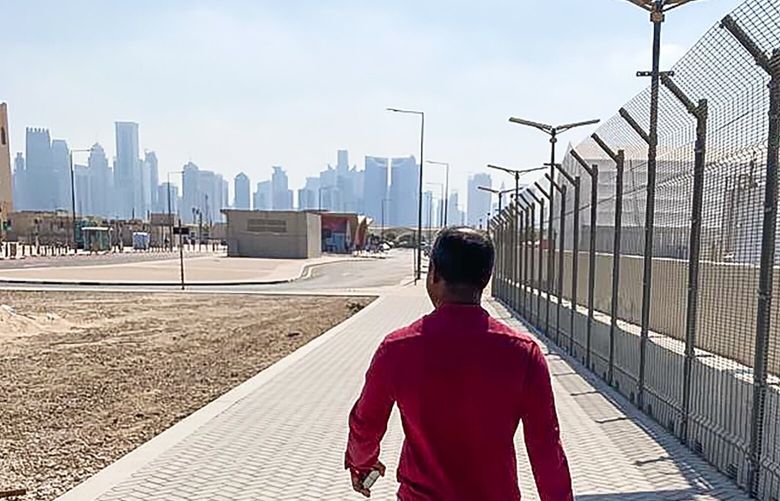 Nazmul, a migrant worker from Bangladesh, has lived and worked in Qatar for six years, walks toward Doha during the World Cup in November 2022. Thousands of the migrant workers who that prepared Qatar for the World Cup have been sent home in recent months, but thousands more like Nazmul remain, hustling for work that not so long ago was easy to find. (Tariq Panja/The New York Times)

 XNYT117 XNYT117