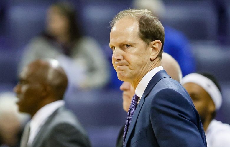 Washington Huskies head coach Mike Hopkins calls a timeout as assistant coaches Will Conroy, left, and Quincy Pondexter greet players on the floor during the first half. 222020