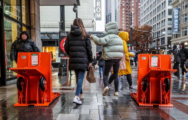 Vehicle barriers decorate the sidewalks of Westlake Park Friday afternoon in downtown Seattle, Washington on November 25, 2022.