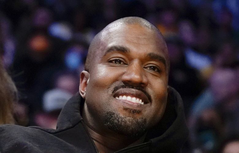 FILE – Kanye West watches the first half of an NBA basketball game between the Washington Wizards and the Los Angeles Lakers in Los Angeles, on March 11, 2022 Adidas says it is investigating allegations of inappropriate workplace conduct by the rapper formerly known as Kanye West that ex-employees made in an anonymous letter also accusing the German sportswear brand of looking the other way. (AP Photo/Ashley Landis, File) NYPS203 NYPS203
