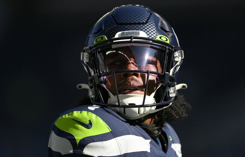 Seattle Seahawks wide receiver Dee Eskridge warms up before an NFL football game against the Arizona Cardinals in Seattle, Sunday, Oct. 16, 2022. (AP Photo/Caean Couto)