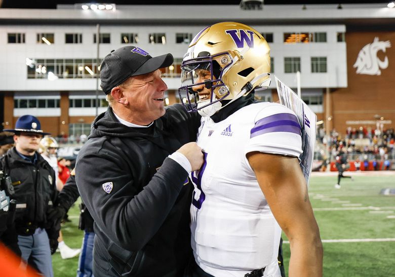 Kalen DeBoer celebrates with Michael Penix Jr. after the Huskies defeated the Cougars in the annual Apple Cup game. (Dean Rutz / The Seattle Times)