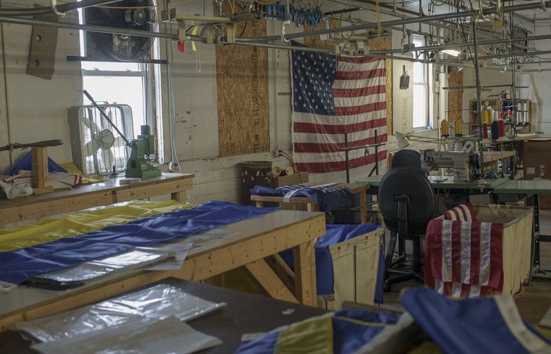 Supplies used to make Ukrainian flags at the Maine Stitching Specialties shop in Skowhegan, Maine, Nov. 23, 2022. Like people in other states, Mainers want to show their solidarity with Ukraine. But it’s more than that. (John Tully/The New York Times)