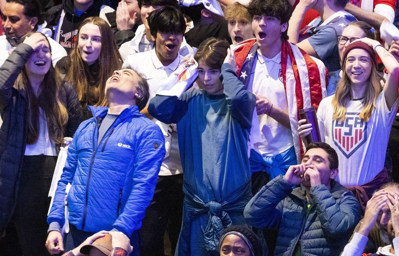 Poulo Sosa of Kirkland (with head back at left) reacts to a play at a  World Cup Watch Party held at The Armory in Seattle Center where the  U.S. takes on England Friday, November 25, 2022.  His sons, Maximiiano (at right of Sosa and Sebastian, at right and slightyly above Maximiiano, wearing a flag)  also react to the play.  The game ended in a 0 – 0 tie and the US will take on Iran Tuesday.

 The  Sounders FC is the only club team to have multiple players selected to the USMNT.

 222286