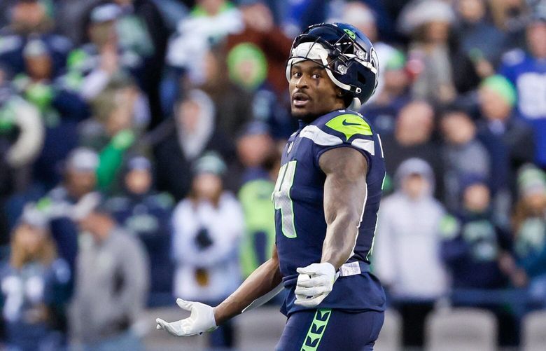 Seattle Seahawks wide receiver DK Metcalf gestures during a replay review of his potential first-down catch during the fourth quarter. After a long review, the play was overturned.  222269