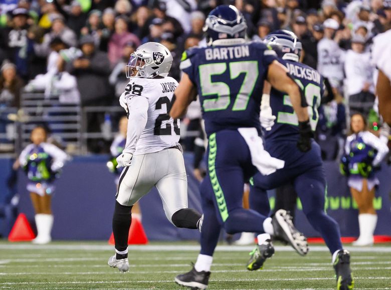 Las Vegas Raiders running back Josh Jacobs is off to the races on his way to a 86-yard game-winning touchdown run during overtime. (Jennifer Buchanan / The Seattle Times)
