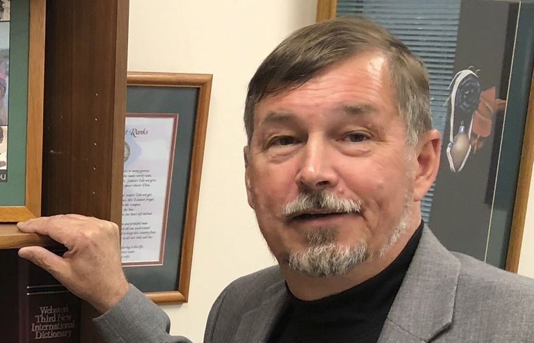 FILE – Oregon Sen. Brian Boquist poses in his office in the Oregon State Capitol in Salem, Ore., Wednesday, July 3, 2019. On Monday, Nov. 28, 2022, a panel of the Oregon Senate rescinded a protective measure it had imposed on Boquist after he made threatening statements during an acrimonious 2019 legislative session. Boquist had been required to give 12 hours notice before coming to the Oregon State Capitol, to give the state police time to beef up their security to ensure the safety of people there. (AP Photo/Andrew Selsky, File) LA106 LA106