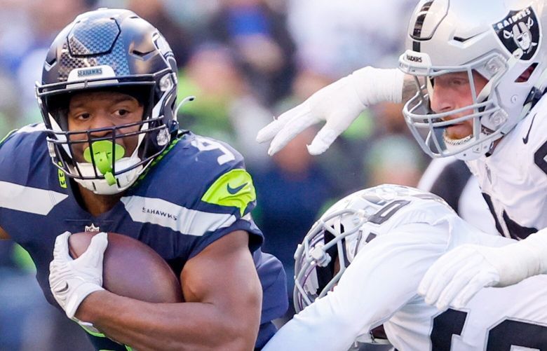 Seattle Seahawks running back Kenneth Walker III gets stopped in the backfield by Las Vegas Raiders cornerback Rock Ya-Sin (26) and defensive end Maxx Crosby during the second quarter. 222269