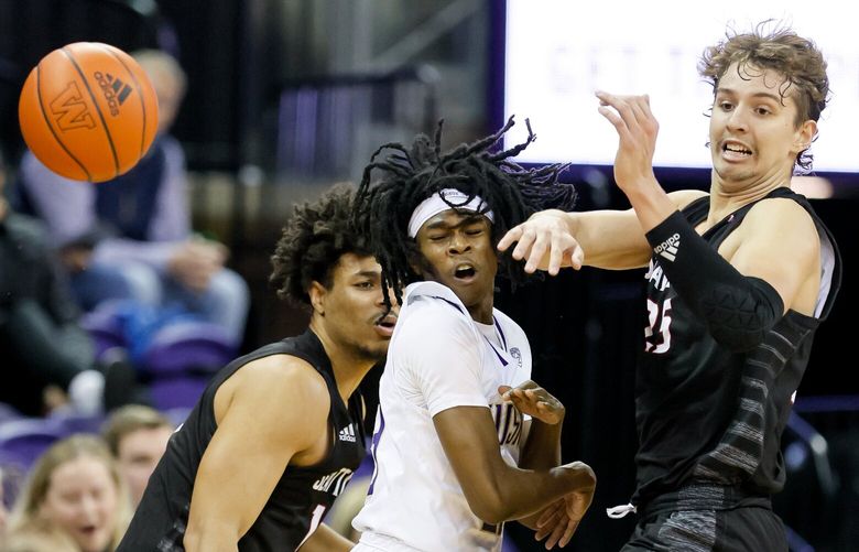 Washington Huskies guard Keyon Menifield steals the ball between Seattle Redhawks guard Riley Grigsby, left, and forward Brandton Chatfield during the first half. 222280