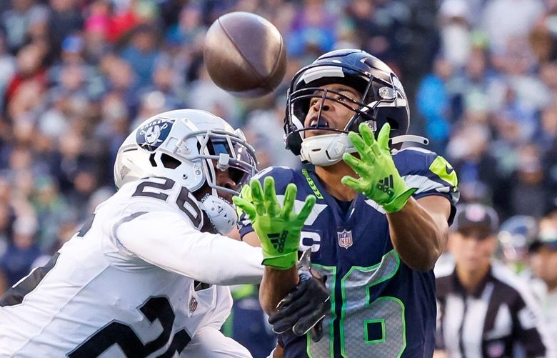 Las Vegas Raiders cornerback Rock Ya-Sin holds down the arm of Seattle Seahawks wide receiver Tyler Lockett as he tries to catch a pass during the fourth quarter. The pass fell incomplete and no foul was called.  222269