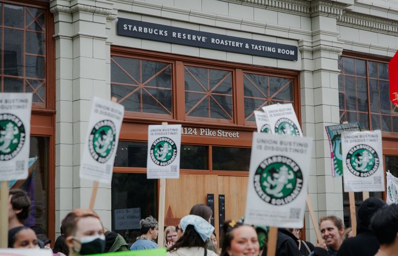 Picketers stand outside the Starbucks Reserve Roastery on the corner of Minor Ave and East Pike Street in the Capitol Hill area of Seattle on July 17, 2022.